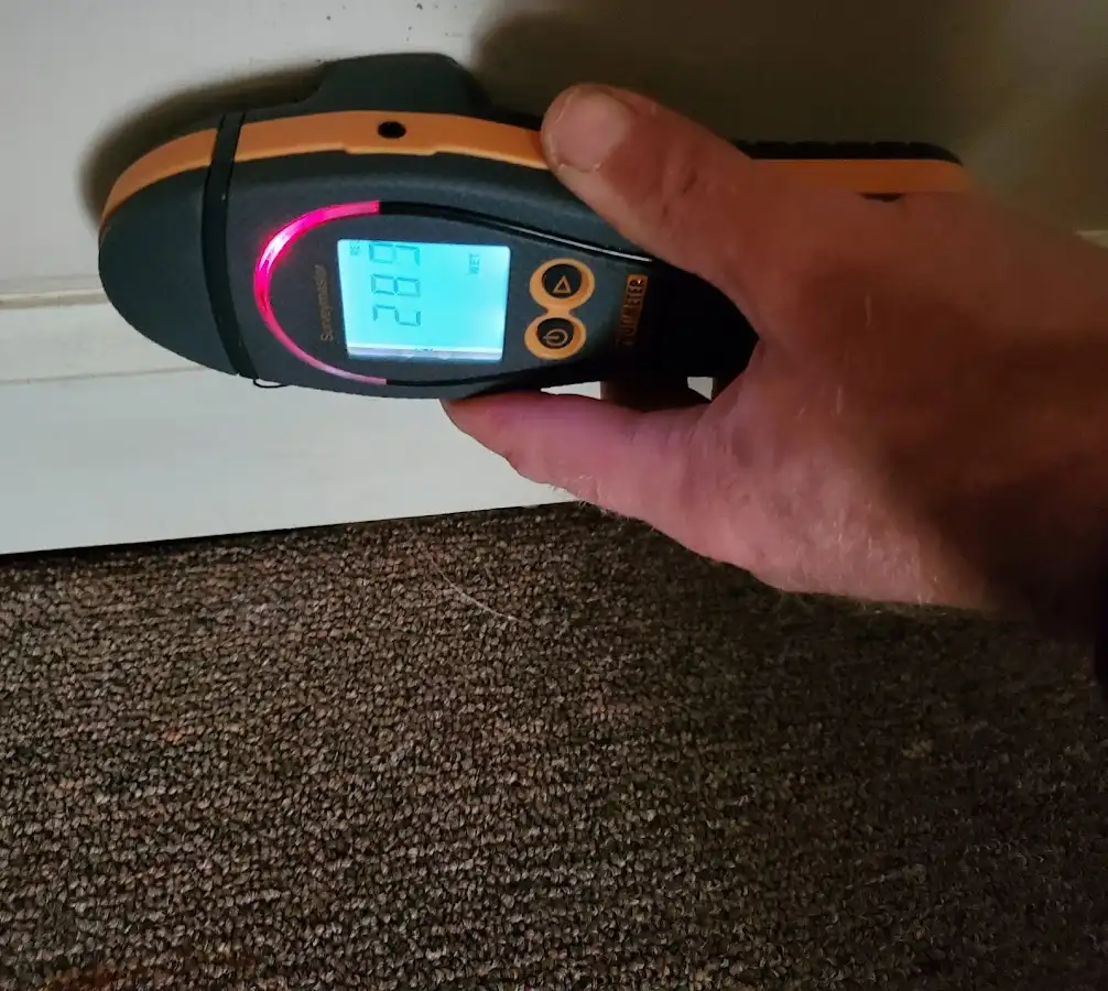 Moisture detection at baseboard during Storm Damage Restoration in Rocky Mount